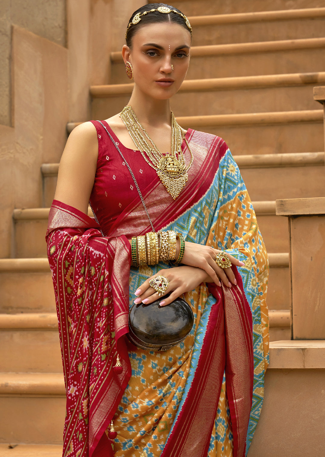 Bask in the Radiant Charm of the Pastel Yellow Woven Patola Silk Saree"