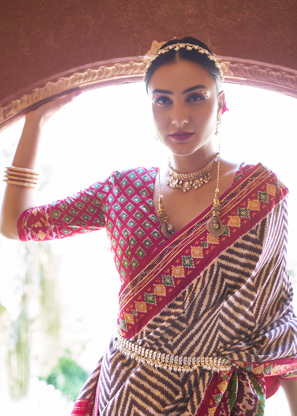 Rustic Elegance: Brown & Pink Printed Patola Silk Saree with Zari Border