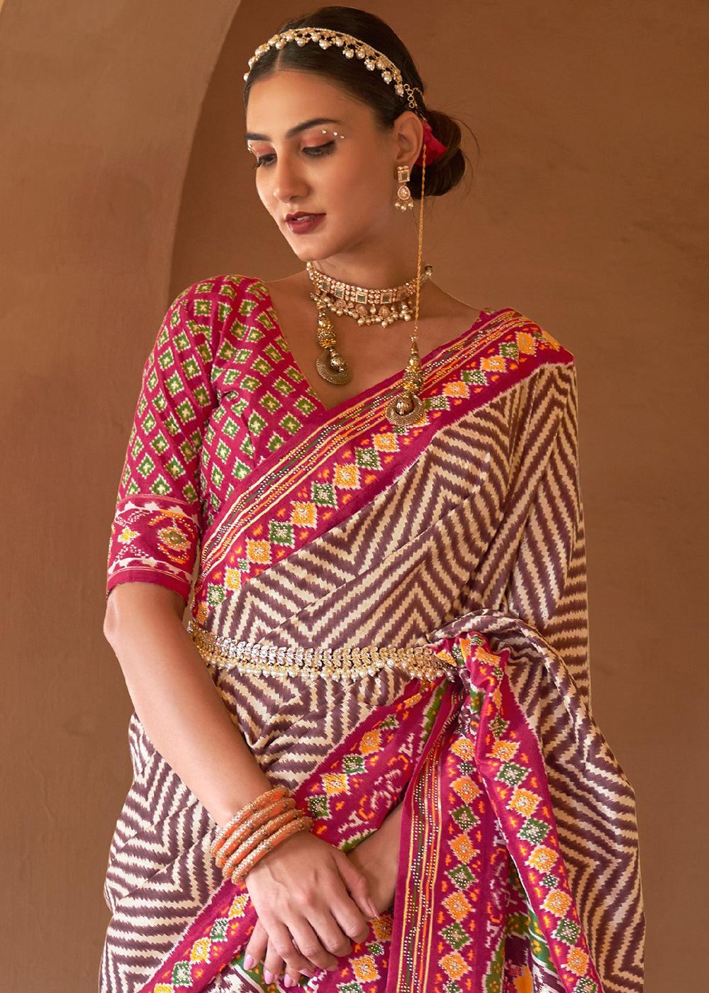 Rustic Elegance: Brown & Pink Printed Patola Silk Saree with Zari Border