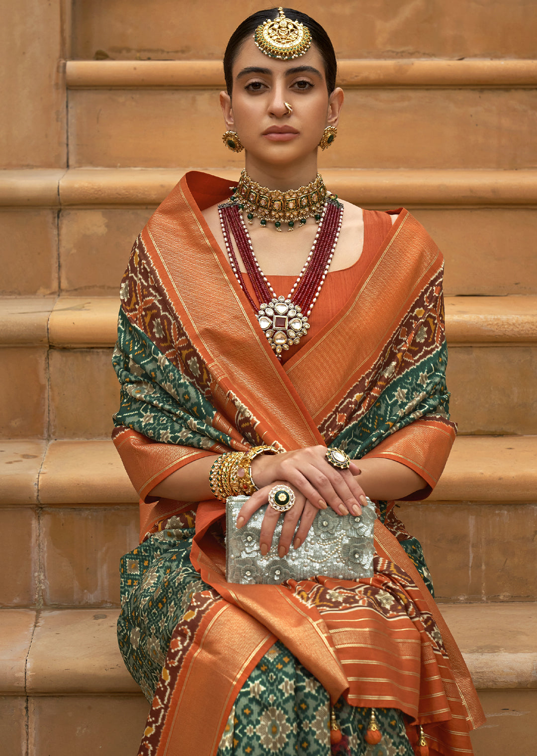 The Perfect Fusion of Vibrance and Elegance: Tea Green and Orange Woven Patola Silk Saree"