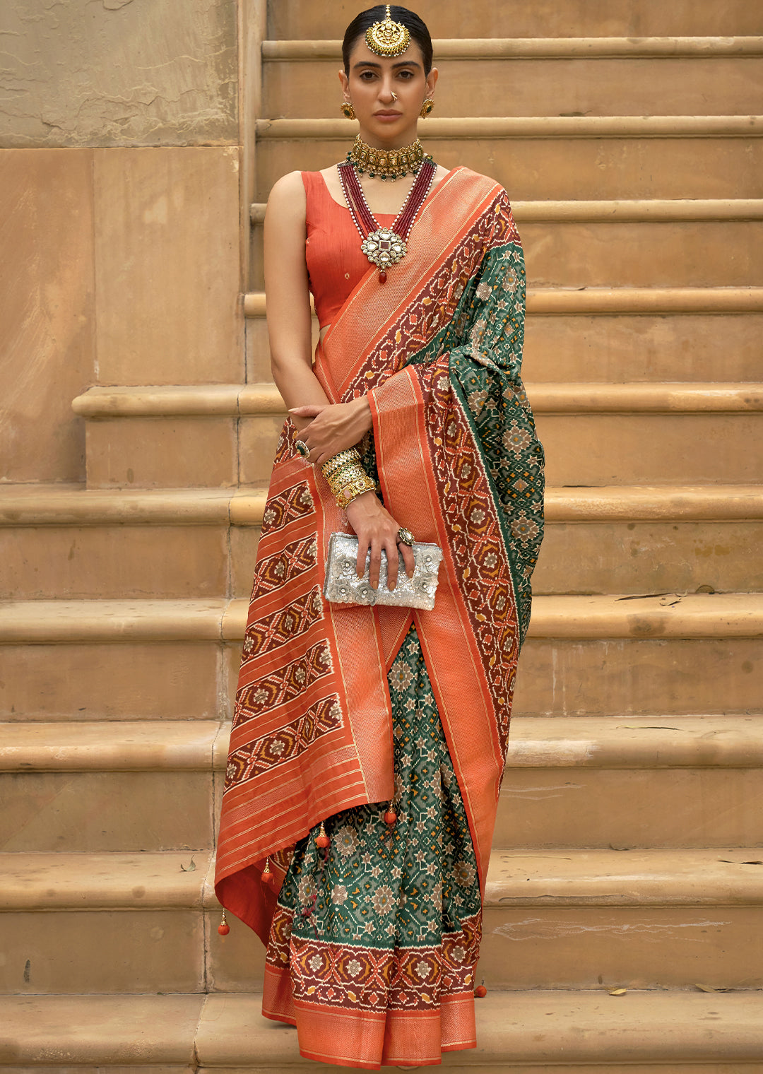 The Perfect Fusion of Vibrance and Elegance: Tea Green and Orange Woven Patola Silk Saree"