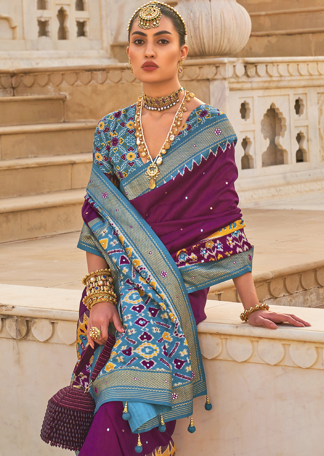 Exude Regal Beauty with the Plum Purple Woven Patola Silk Saree"