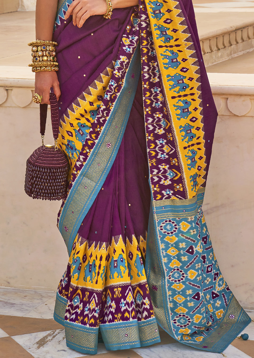 Exude Regal Beauty with the Plum Purple Woven Patola Silk Saree"