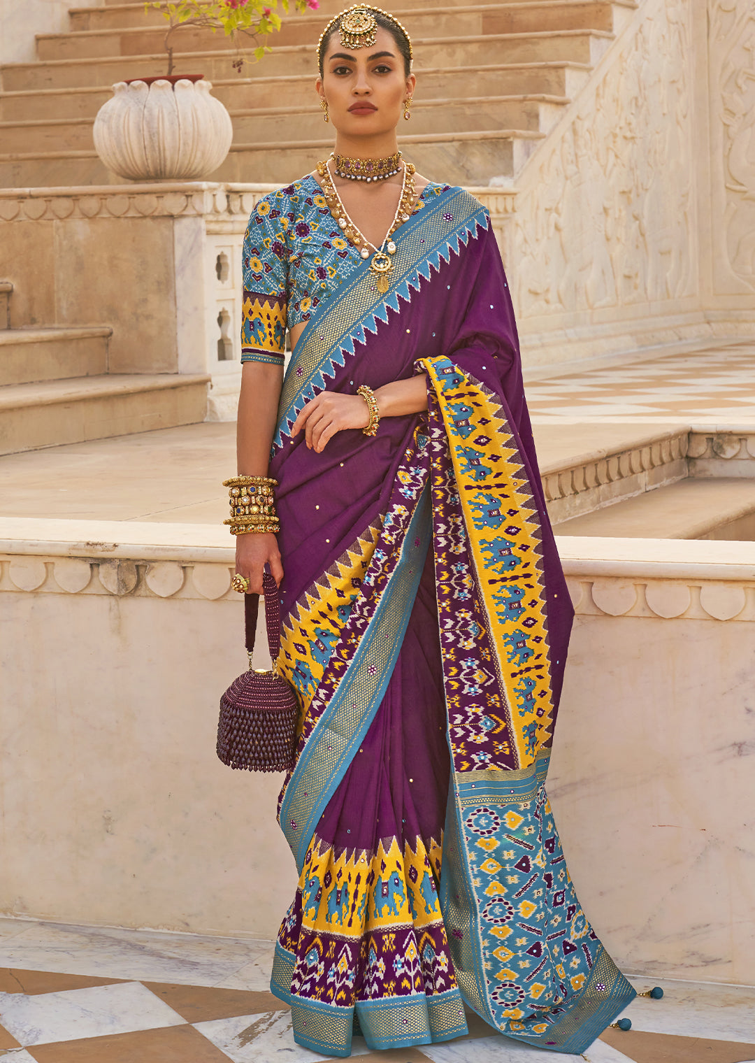 Exude Regal Beauty with the Plum Purple Woven Patola Silk Saree"